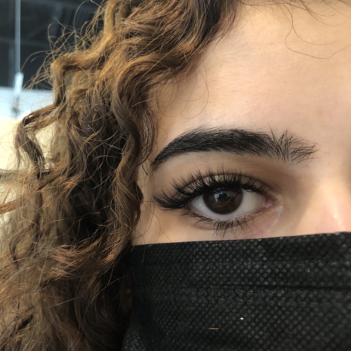 Woman with beautiful lash extensions enjoying winter activities in Saskatoon